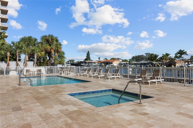 view of pool featuring a community hot tub and a patio