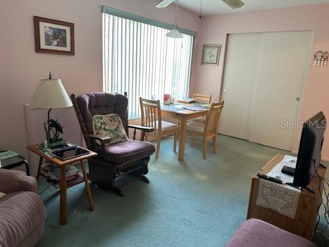 sitting room featuring carpet and ceiling fan