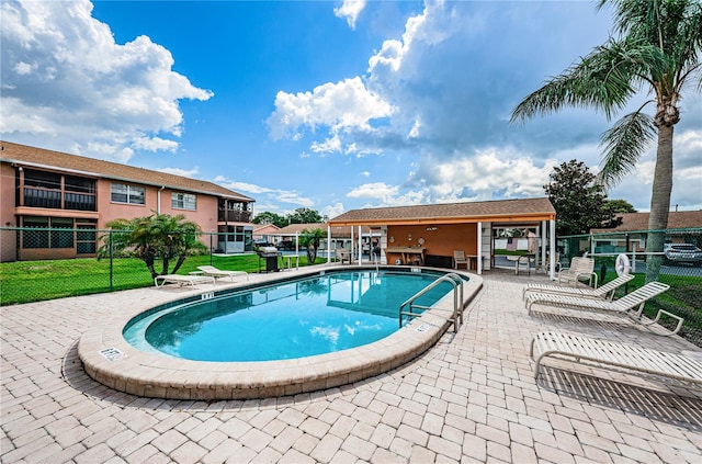 view of swimming pool with a patio and a yard