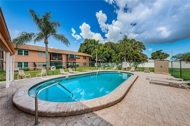 view of pool featuring a yard and a patio area