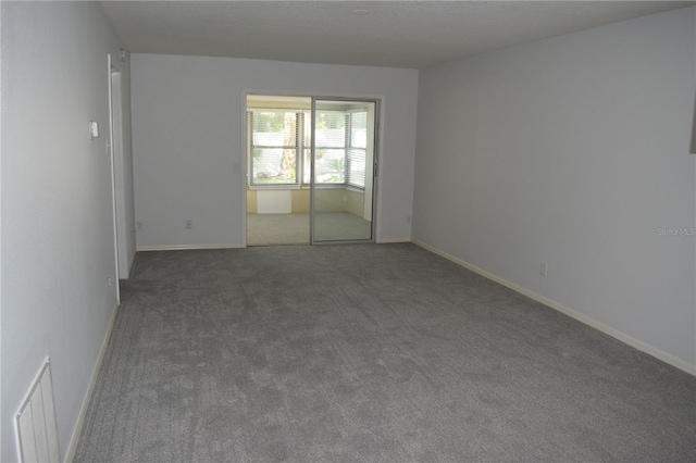 empty room featuring dark carpet