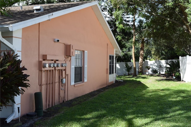 view of side of home with a yard