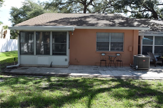 back of property featuring a yard, central AC, and a patio area