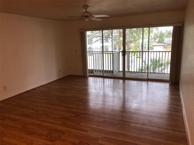 empty room featuring ceiling fan, dark hardwood / wood-style floors, and a textured ceiling