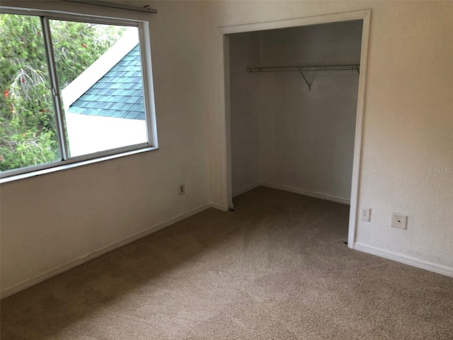 unfurnished bedroom with carpet floors and a closet