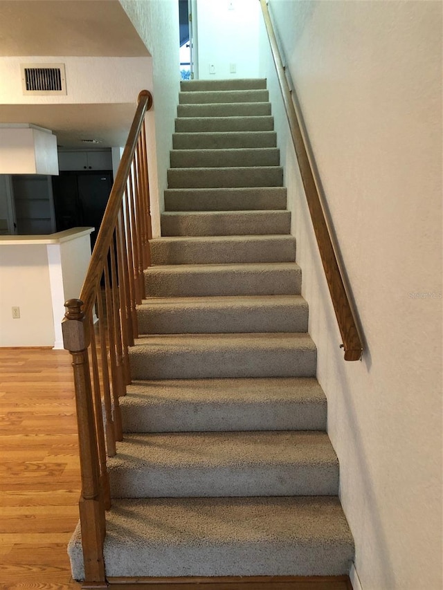 stairs with wood-type flooring