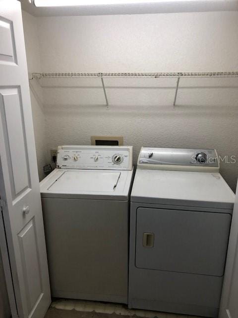 clothes washing area with washer and dryer