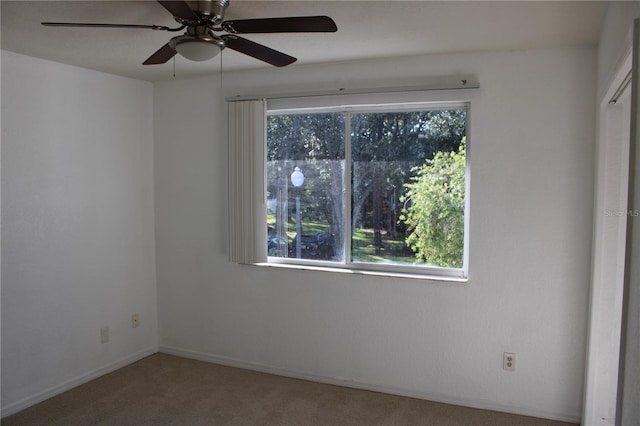 unfurnished room with carpet and ceiling fan