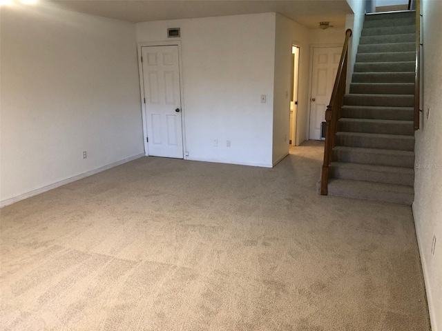 unfurnished room featuring light carpet