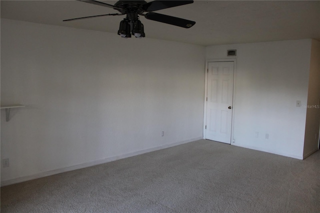 spare room with ceiling fan and light colored carpet