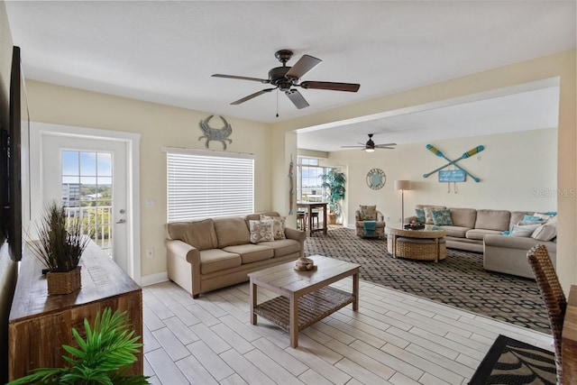 living room featuring ceiling fan and light hardwood / wood-style floors