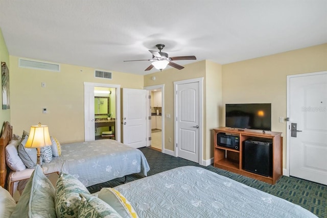 carpeted bedroom featuring ceiling fan and ensuite bathroom