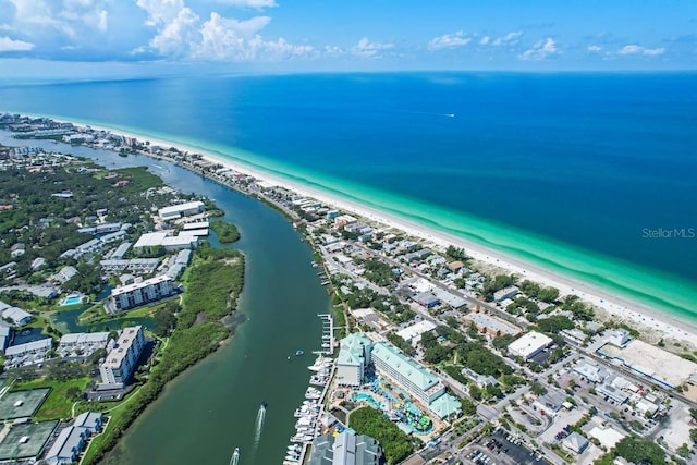 birds eye view of property with a water view and a beach view