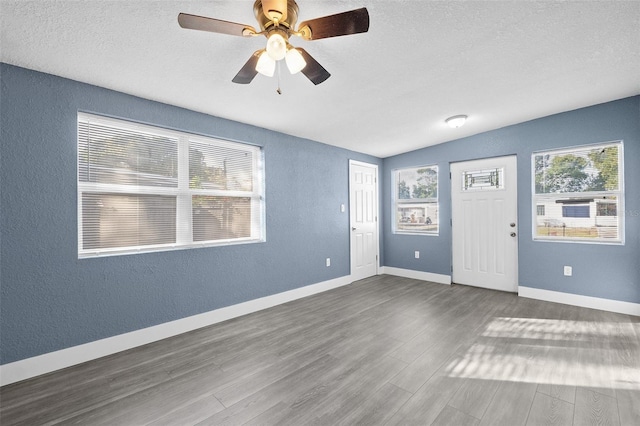 interior space featuring ceiling fan, dark wood-type flooring, and vaulted ceiling