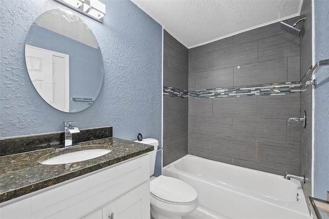 full bathroom with vanity, toilet, a textured ceiling, and tiled shower / bath combo