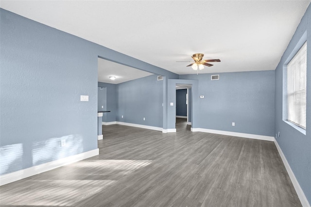 unfurnished room with ceiling fan and dark wood-type flooring