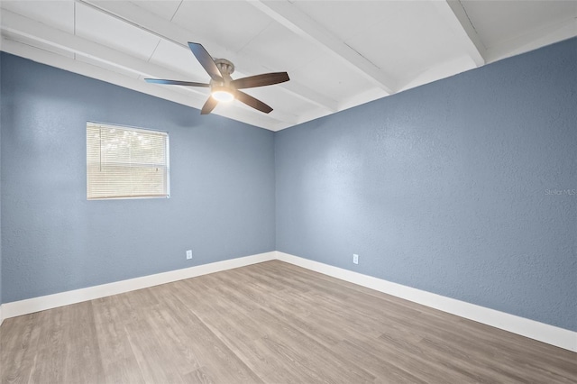 unfurnished room featuring hardwood / wood-style flooring, lofted ceiling with beams, and ceiling fan