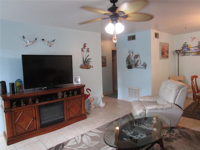 living room with ceiling fan and light tile patterned flooring