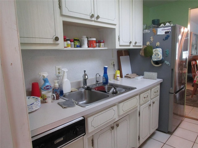 kitchen featuring white cabinetry, sink, stainless steel fridge, dishwashing machine, and light tile patterned floors