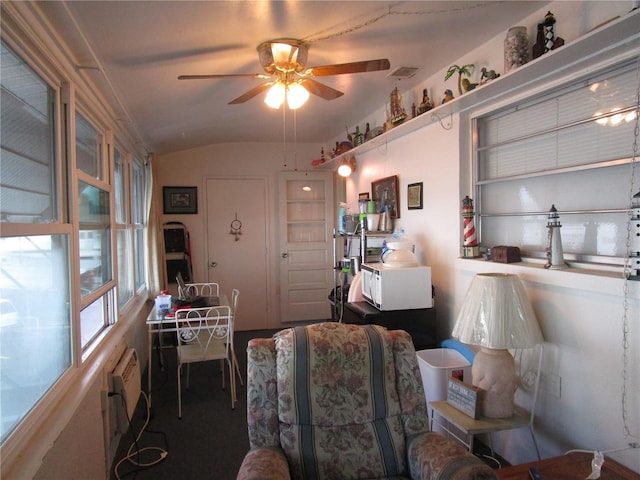 dining space featuring a wall unit AC, ceiling fan, and lofted ceiling