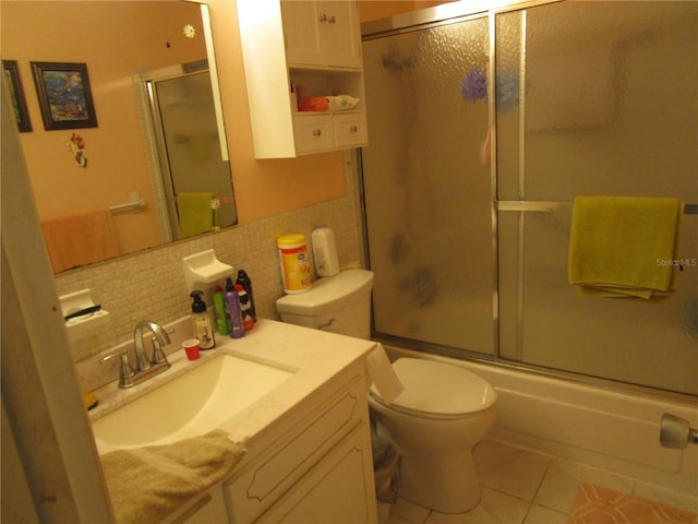 full bathroom featuring vanity, tile patterned floors, toilet, enclosed tub / shower combo, and tasteful backsplash