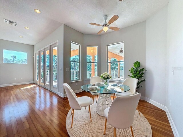 dining space featuring visible vents, baseboards, and wood finished floors