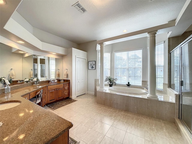 full bath with visible vents, a stall shower, decorative columns, a bath, and vanity