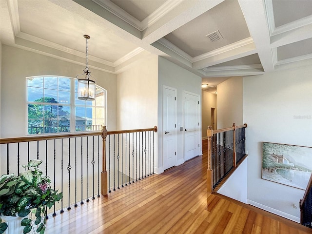 corridor featuring wood finished floors, an upstairs landing, visible vents, and coffered ceiling