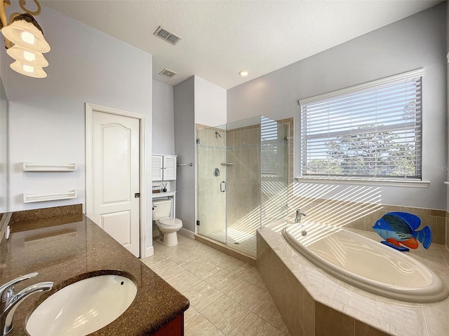 bathroom featuring vanity, visible vents, a shower stall, a garden tub, and toilet