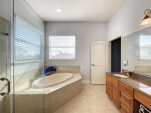 full bathroom with a shower with shower door, tile patterned floors, a garden tub, a textured ceiling, and vanity