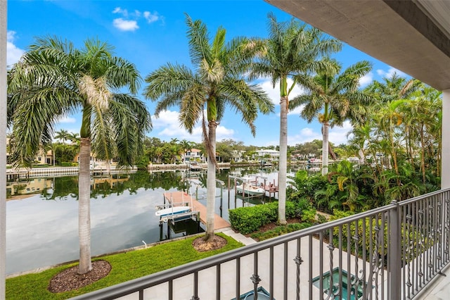 balcony featuring a boat dock, a water view, and boat lift