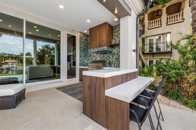 interior space featuring an outdoor kitchen, grilling area, and outdoor dry bar