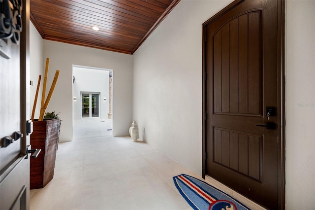 hallway with wooden ceiling, light tile patterned floors, and crown molding