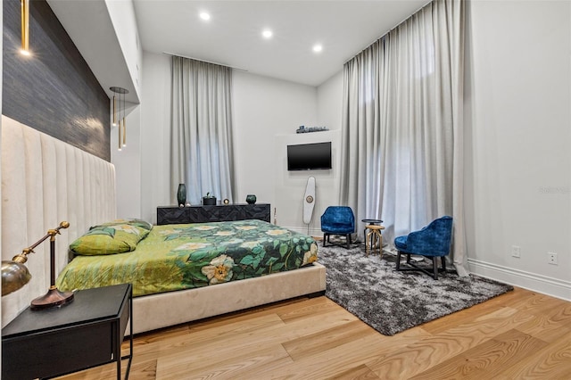 bedroom featuring recessed lighting, wood finished floors, and baseboards