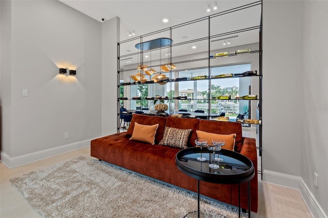 living area with a towering ceiling and baseboards