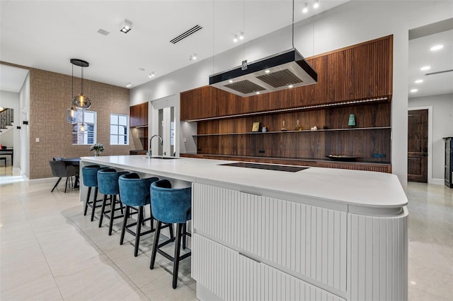 kitchen with open shelves, modern cabinets, ventilation hood, pendant lighting, and a sink