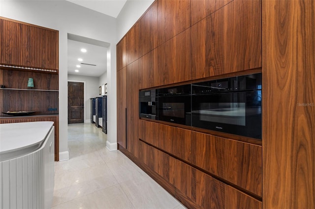 kitchen featuring light tile patterned floors, open shelves, baseboards, and modern cabinets