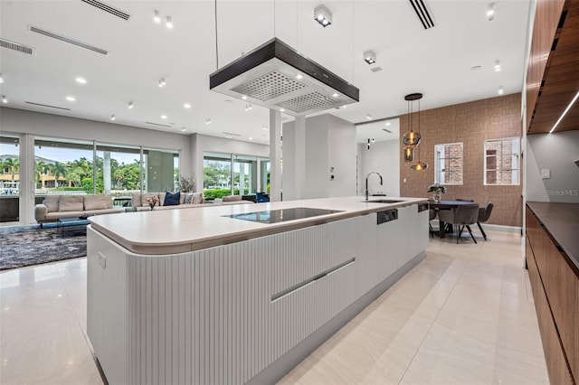 kitchen featuring black electric stovetop, a spacious island, white cabinets, open floor plan, and modern cabinets