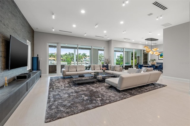 living room featuring baseboards, visible vents, and recessed lighting