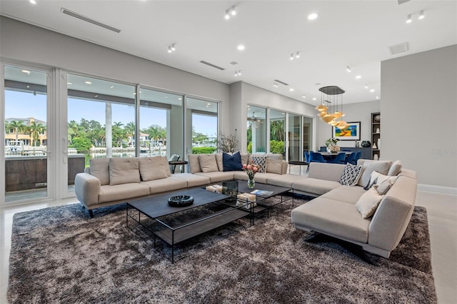 living room featuring baseboards, visible vents, and recessed lighting