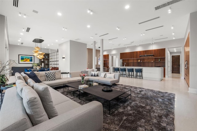 living area featuring recessed lighting and visible vents