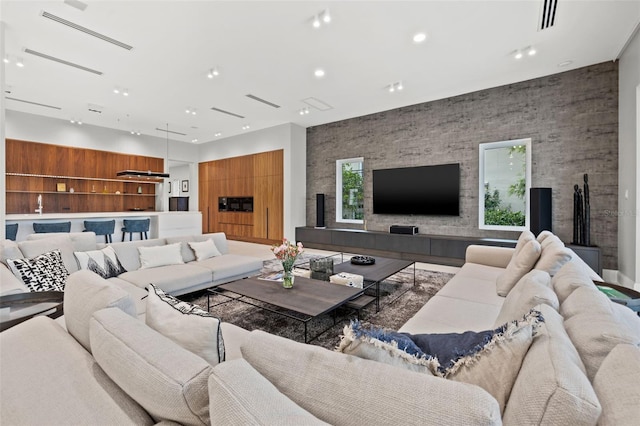 living area featuring visible vents and recessed lighting