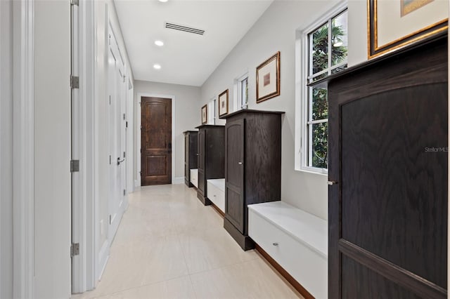 mudroom with light tile patterned floors, recessed lighting, visible vents, and baseboards