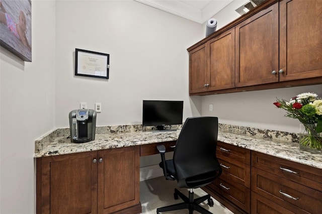 office space with built in desk and crown molding