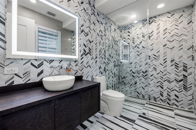 bathroom with visible vents, toilet, walk in shower, vanity, and recessed lighting