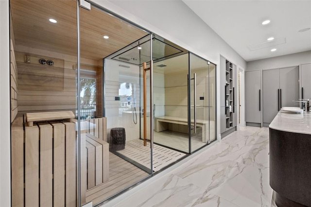 full bathroom featuring marble finish floor, a shower stall, vanity, and recessed lighting