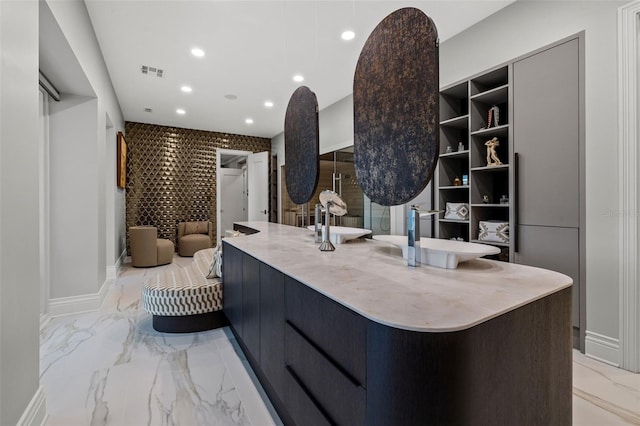 kitchen with recessed lighting, marble finish floor, light countertops, open shelves, and modern cabinets