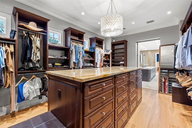 walk in closet featuring light wood finished floors and visible vents