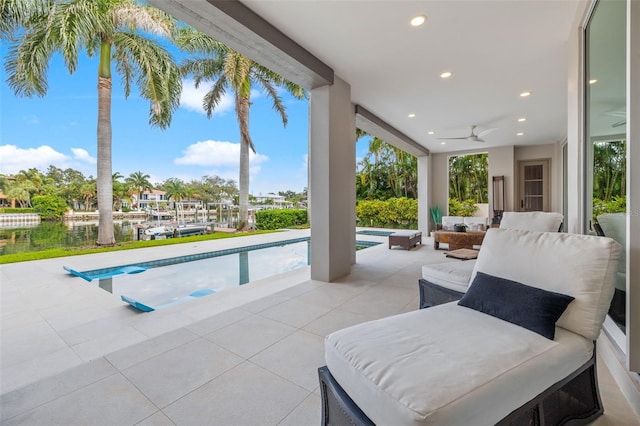 outdoor pool featuring ceiling fan and a patio area