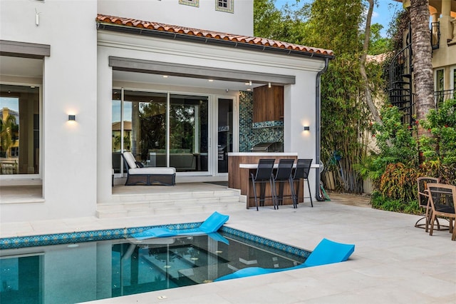 view of patio featuring fence and outdoor dry bar